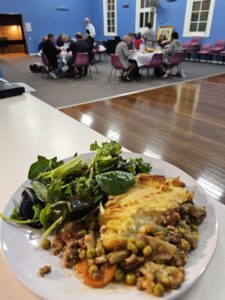 Meal with blurred guests in background