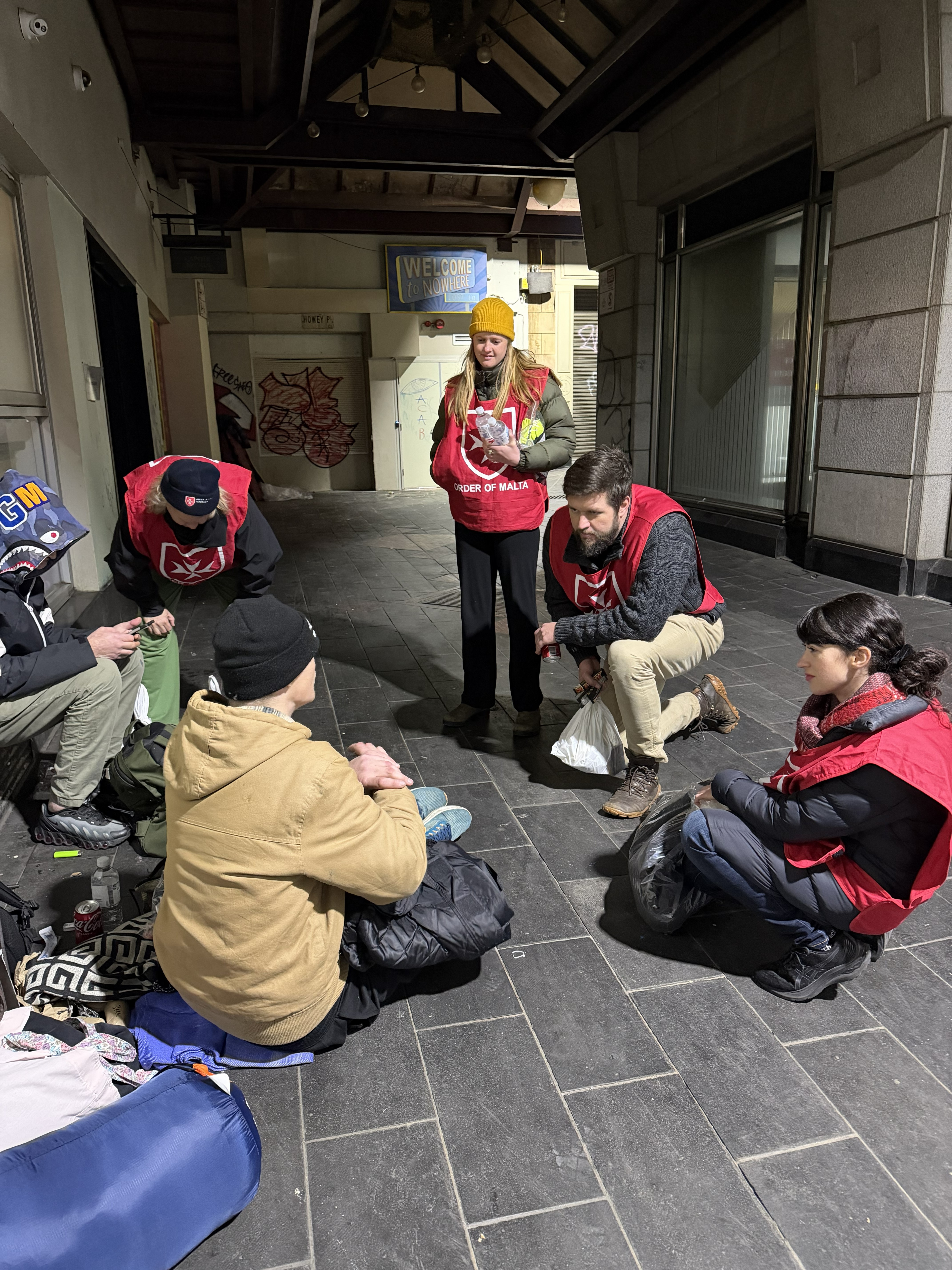 volunteers talking with homeless
